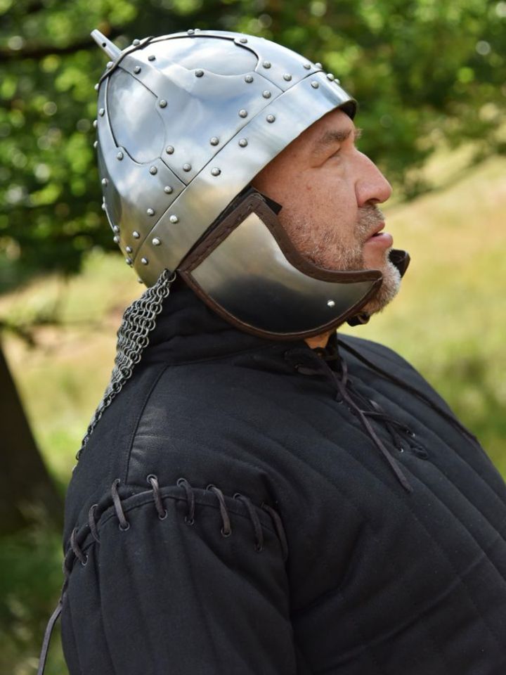 Rivited plate helmet with cheek flap